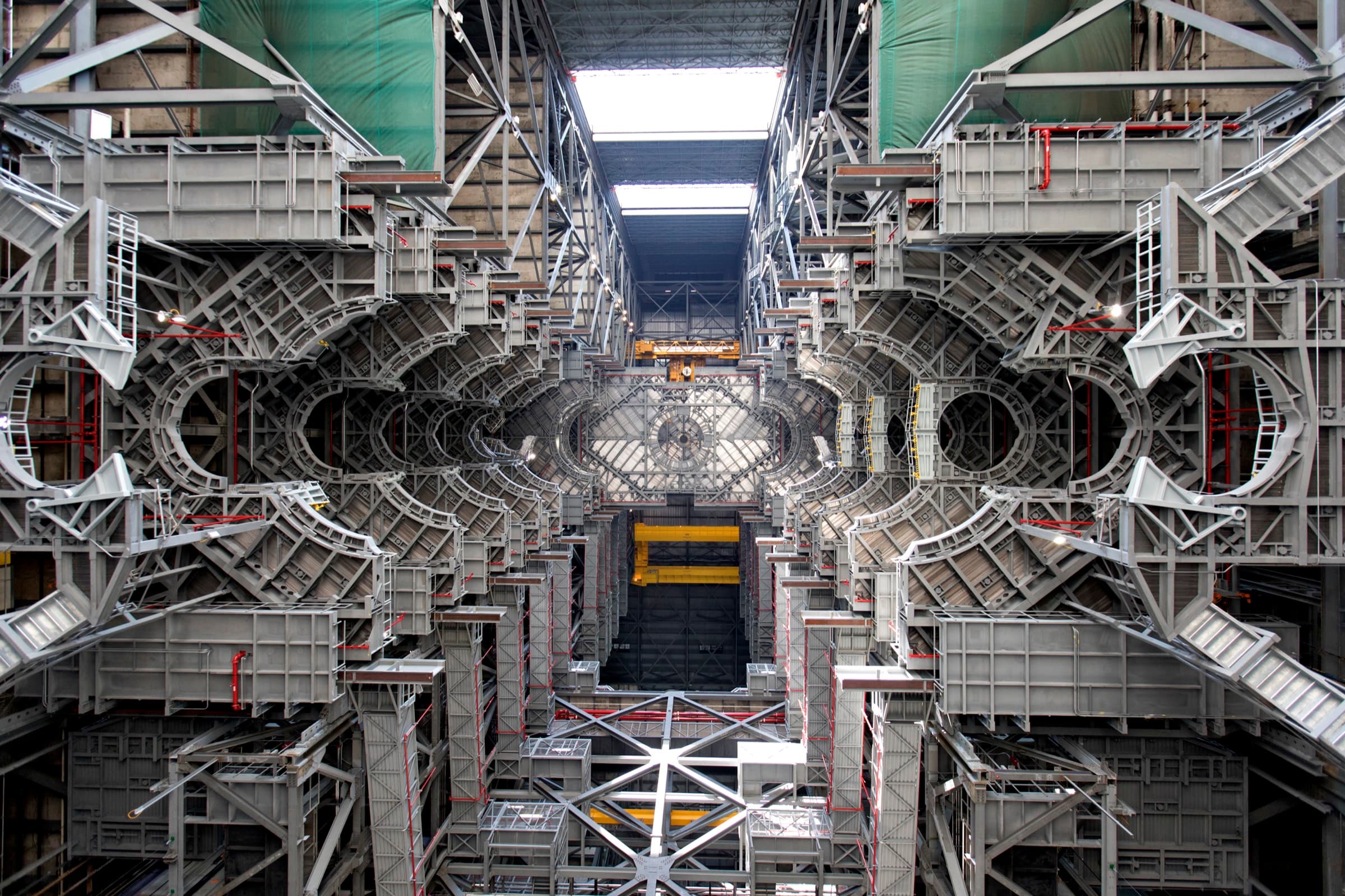 The interior of a rocket assembly high bay, looking up through ten symmetrical levels of steel work platforms.